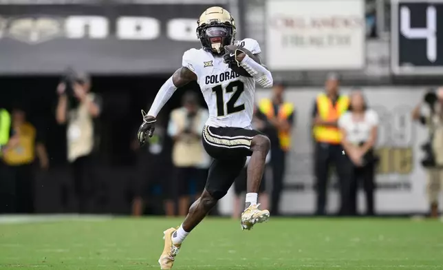 FILE - Colorado wide receiver Travis Hunter (12) runs after catching a pass during the first half of an NCAA college football game against Central Florida, Saturday, Sept. 28, 2024, in Orlando, Fla. (AP Photo/Phelan M. Ebenhack, File)