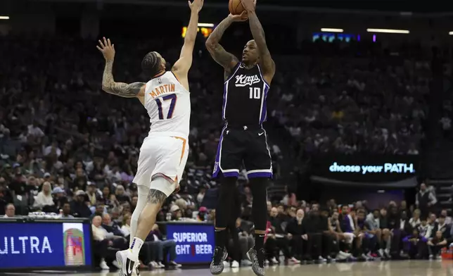 Sacramento Kings forward DeMar DeRozan (10) attempts a shot over Phoenix Suns guard Cody Martin (17) during the first half of an NBA basketball game Sunday, April 13, 2025, in Sacramento, Calif. (AP Photo/Scott Marshall)