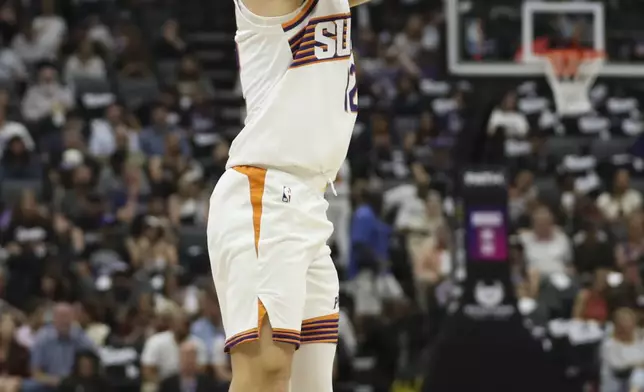 Phoenix Suns guard Collin Gillespie attempts a shot against the Sacramento Kings during the first half of an NBA basketball game Sunday, April 13, 2025, in Sacramento, Calif. (AP Photo/Scott Marshall)
