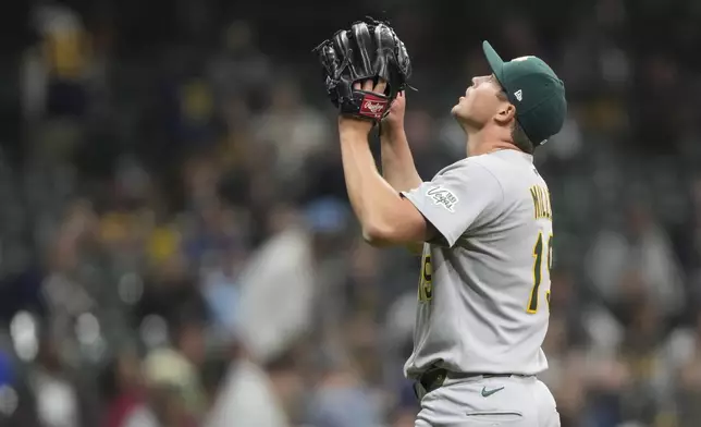 Athletics' Mason Miller gestures after recording a save during the ninth inning of a baseball game against the Milwaukee Brewers, Saturday, April 19, 2025, in Milwaukee. (AP Photo/Aaron Gash)