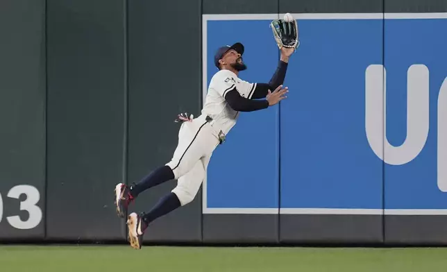 Minnesota Twins center fielder Byron Buxton (25) catches a fly out by Chicago White Sox's Andrew Benintendi (23) as the final out of a baseball game Tuesday, April 22, 2025, in Minneapolis. (AP Photo/Abbie Parr)