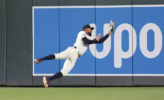 Minnesota Twins center fielder Byron Buxton (25) catches a fly out by Chicago White Sox's Andrew Benintendi (23) as the final out of a baseball game Tuesday, April 22, 2025, in Minneapolis. (AP Photo/Abbie Parr)