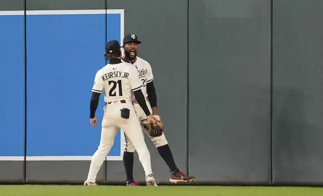 Minnesota Twins center fielder Byron Buxton (25) celebrates with left fielder DaShawn Keirsey Jr. (21) after catching a fly out by Chicago White Sox's Andrew Benintendi (23) as the final out of a baseball game Tuesday, April 22, 2025, in Minneapolis. (AP Photo/Abbie Parr)