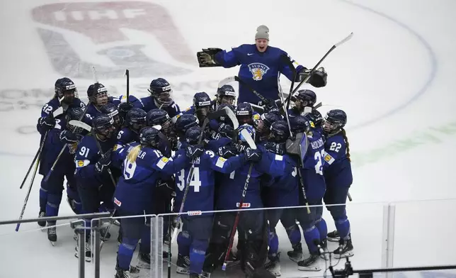 Finland's celebrate after winning the bronze medal match between Czech Republic and Finland at the Women's Ice Hockey Championships in Ceske Budejovice, Czech Republic, Sunday, April 20, 2025. (AP Photo/Petr David Josek)