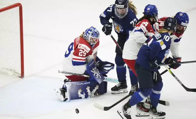 Klara Peslarova of Czech Republic, left, makes a save during the bronze medal match between Czech Republic and Finland at the Women's Ice Hockey Championships in Ceske Budejovice, Czech Republic, Sunday, April 20, 2025. (AP Photo/Petr David Josek)
