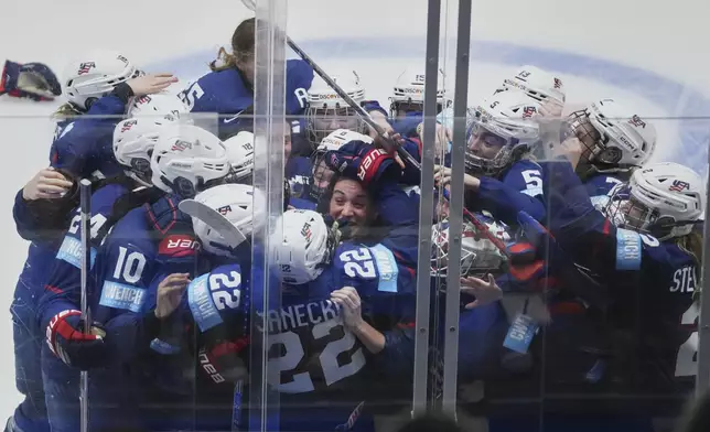 United States players celebrate winning the gold medal match between Canada and United States at the Women's Ice Hockey Championships in Ceske Budejovice, Czech Republic, Sunday, April 20, 2025. (AP Photo/Petr David Josek)
