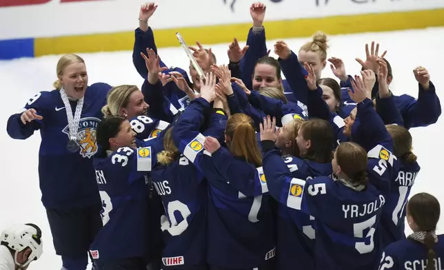 Finland's celebrate after winning the bronze medal match between Czech Republic and Finland at the Women's Ice Hockey Championships in Ceske Budejovice, Czech Republic, Sunday, April 20, 2025. (AP Photo/Petr David Josek)