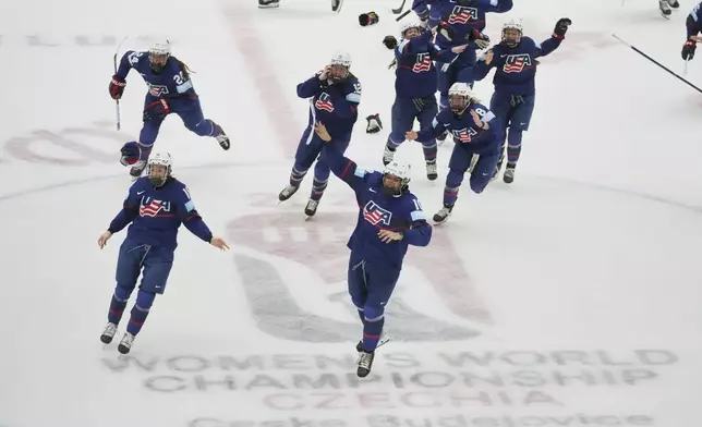 United States players celebrate winning the gold medal match between Canada and United States at the Women's Ice Hockey Championships in Ceske Budejovice, Czech Republic, Sunday, April 20, 2025. (AP Photo/Petr David Josek)