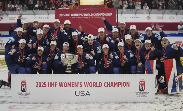 United states players celebrate with a trophy after the gold medal match between Canada and United States at the Women's Ice Hockey Championships in Ceske Budejovice, Czech Republic, Sunday, April 20, 2025. (AP Photo/Petr David Josek)