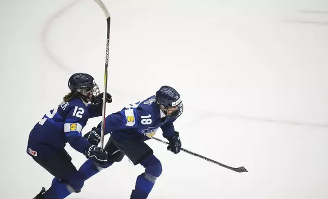 Finland's Jenniina Nylund, right, celebrates with Finland's Sanni Vanhanen after scoring her sides winning goal during the bronze medal match between Czech Republic and Finland at the Women's Ice Hockey Championships in Ceske Budejovice, Czech Republic, Sunday, April 20, 2025. (AP Photo/Petr David Josek)