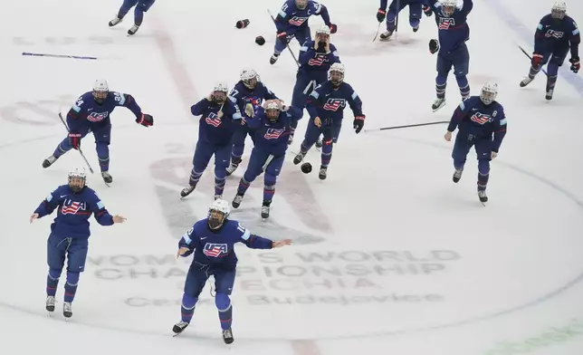United States players celebrate winning the gold medal match between Canada and United States at the Women's Ice Hockey Championships in Ceske Budejovice, Czech Republic, Sunday, April 20, 2025. (AP Photo/Petr David Josek)
