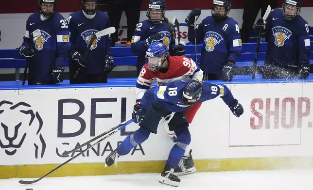 Finland's Jenniina Nylund, right, challenges Kristyna Kaltounkova of Czech Republic during the bronze medal match between Czech Republic and Finland at the Women's Ice Hockey Championships in Ceske Budejovice, Czech Republic, Sunday, April 20, 2025. (AP Photo/Petr David Josek)