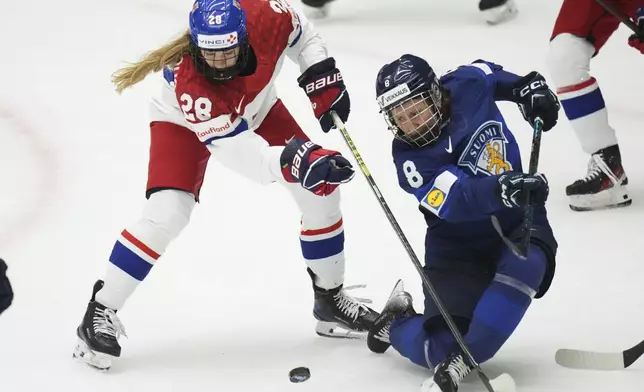 Finland's Elli Suoranta, right, challenges Noemi Neubauerova of Czech Republic during the bronze medal match between Czech Republic and Finland at the Women's Ice Hockey Championships in Ceske Budejovice, Czech Republic, Sunday, April 20, 2025. (AP Photo/Petr David Josek)
