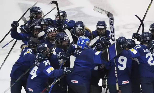Finland's players celebrate after winning the bronze medal match between Czech Republic and Finland at the Women's Ice Hockey Championships in Ceske Budejovice, Czech Republic, Sunday, April 20, 2025. (AP Photo/Petr David Josek)