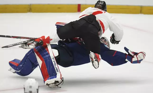 Canada's Laura Stacey collides with United States' goalkeeper Aerin Frankel during the gold medal match between Canada and United States at the Women's Ice Hockey Championships in Ceske Budejovice, Czech Republic, Sunday, April 20, 2025. (AP Photo/Petr David Josek)