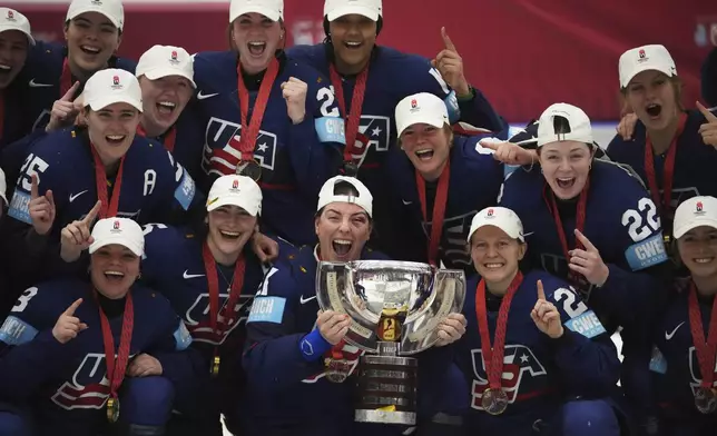 United states players celebrate with a trophy after the gold medal match between Canada and United States at the Women's Ice Hockey Championships in Ceske Budejovice, Czech Republic, Sunday, April 20, 2025. (AP Photo/Petr David Josek)