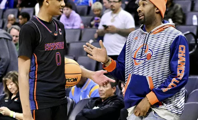 Chatsworth High School basketball player Alijah Arenas, left, talks to his dad, former NBA player Gilbert Arenas before a CIF State Division IV championship basketball game in Sacramento, Saturday, March 9, 2024. (Keith Birmingham/The Orange County Register via AP)