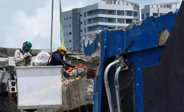 Rescue workers cut a wall while searching for survivors at the Jet Set nightclub after its roof collapsed two days prior during a merengue concert in Santo Domingo, Dominican Republic, Wednesday, April 9, 2025. (AP Photo/Ricardo Hernandez)