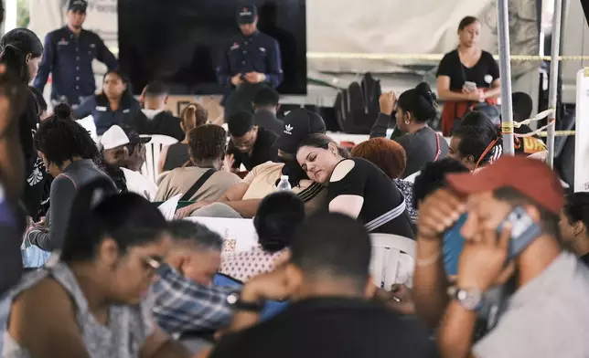 Relatives wait as rescue workers search for survivors at the Jet Set nightclub after its roof collapsed two nights prior during a merengue concert in Santo Domingo, Dominican Republic, early Wednesday, April 9, 2025. (AP Photo/Ricardo Hernandez)