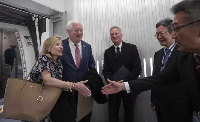 U.S. Ambassador to Japan George Glass, second left, and his wife Mary, left, are welcomed by Joseph Young, center, Acting Deputy Chief of Mission at the US Embassy in Tokyo, Eiichi Kawahara, second right, Ambassador Special Assistant to the Minister for Foreign Affairs, and Victor Osumi, right, President of Japan Operations of Delta, upon their arrival at Haneda Airport in Tokyo Friday, April 18, 2025. (Kazuhiro Nogi/Pool Photo via AP)