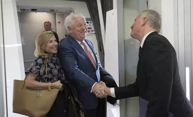 U.S. Ambassador to Japan George Glass, center, and his wife Mary are welcomed by Joseph Young, acting deputy chief of mission at the U.S. Embassy in Tokyo, upon their arrival at Haneda Airport in Tokyo Friday, April 18, 2025. (Kazuhiro Nogi/Pool Photo via AP)