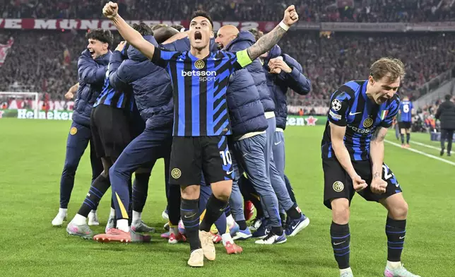 Inter's Lautaro Martinez, center, and Nicolo Barella, right, celebrate after the Champions League quarterfinals first leg soccer match between FC Bayern Munich and Inter Milan, at the Allianz Arena in Munich, Germany, Tuesday, April 8, 2025. (Peter Kneffel/dpa via AP)