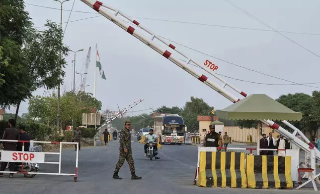 CORRECTS THE NAME OF THE TOWN TO WAGAH, NOT WAHAG - Pakistan's paramilitary soldiers stand guard at a checkpoint near Wagah, a joint border crossing point between the Pakistan and India border, Thursday, April 24, 2025.(AP Photo/K.M. Chaudary)