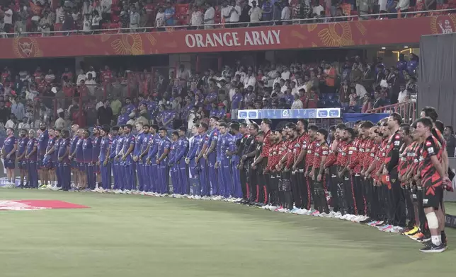 Players of Sunrisers Hyderabad and Mumbai Indians pay tribute to the victims of terrorist attack on tourists in Kashmir, during the Indian Premier League cricket match between Sunrisers Hyderabad and Mumbai Indians at Rajiv Gandhi International Cricket Stadium in Hyderabad, India, Wednesday, April 23, 2025. (AP Photo/Mahesh Kumar A.)