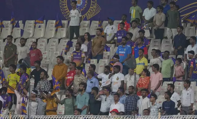 Fans at stands observe a moment of silence in solidarity with the victims of the recent terror attack in Kashmir before the Indian Premier League cricket match between Kolkata Knight Riders and Punjab Kings at Eden Gardens in Kolkata in Kolkata , India, Saturday, April 26, 2025. (AP Photo/Bikas Das)