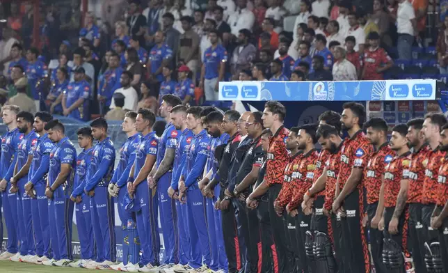 Players of Sunrisers Hyderabad and Mumbai Indians pay tribute to the victims of terrorist attack on tourists in Kashmir, during the Indian Premier League cricket match between Sunrisers Hyderabad and Mumbai Indians at Rajiv Gandhi International Cricket Stadium in Hyderabad, India, Wednesday, April 23, 2025. (AP Photo/Mahesh Kumar A.)