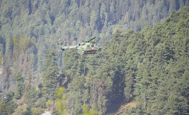 An Indian army helicopter patrols above Pahalgam a day after militants indiscriminately opened fire on tourists near the town, Indian controlled Kashmir, Wednesday, April 23, 2025. (AP Photo/Dar Yasin)