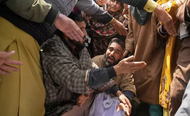 A relative wails during the funeral procession of Adil Hussain Shah, a daily-wage worker, who died when militants indiscriminately opened fire on a crowd of mainly tourists on Tuesday, at his village Hapatnar, about 20 km (13 miles) from Pahalgam where the incident took place, Indian controlled Kashmir, Wednesday, April 23, 2025. (AP Photo/Dar Yasin)