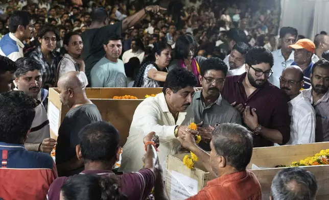 Mourners pay last respect to Hemant Joshi, Sanjay Lele and Atul Mone, who were victims in a deadly attack on tourists in the Pahalgam region of Indian-administered Kashmir, at Dombivali near Mumbai, India, Wednesday, April. 23, 2025.(AP Photo/Rajanish Kakade)
