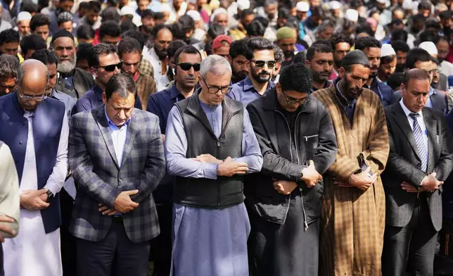 Chief Minister of Jammu &amp; Kashmir, Omar Abdullah, front center, in a blue-gray shirt, prays with the congregation at the funeral of Adil Hussain Shah, a daily-wage worker, who died when militants indiscriminately opened fire on a crowd of mainly tourists on Tuesday, at his village Hapatnar, about 20 km (13 miles) from Pahalgam where the incident took place, Indian controlled Kashmir, Wednesday, April 23, 2025. (AP Photo/Dar Yasin)