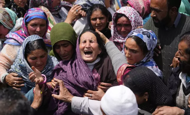 Relatives wail during the funeral procession of Adil Hussain Shah, a daily-wage worker, who died when militants indiscriminately opened fire on a crowd of mainly tourists on Tuesday, at his village Hapatnar, about 20 km (13 miles) from Pahalgam where the incident took place, Indian controlled Kashmir, Wednesday, April 23, 2025. (AP Photo/Dar Yasin)