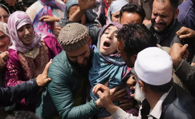 A relative wails during the funeral procession of Adil Hussain Shah, a daily-wage worker, who died when militants indiscriminately opened fire on a crowd of mainly tourists on Tuesday, at his village Hapatnar, about 20 km (13 miles) from Pahalgam where the incident took place, Indian controlled Kashmir, Wednesday, April 23, 2025. (AP Photo/Dar Yasin)
