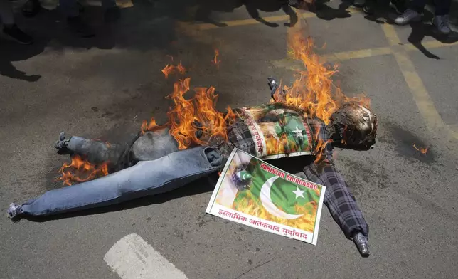 Supporters of Akhil Bharatiya Vidhyarthi Parishad, or All India Students' Council burn an effigy of terrorism during a protest against the killing of tourists by militants near Pahalgam in Indian controlled Kashmir, in Ahmedabad, India, Thursday, April 24, 2025. Poster read in Hindi " Down with Islamic terrorism". (AP Photo/Ajit Solanki)