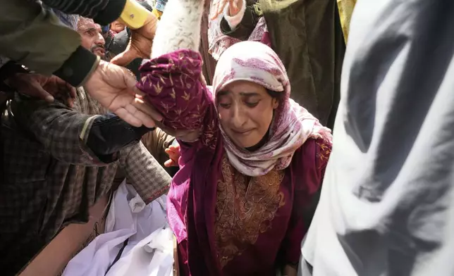 A relative wails during the funeral procession of Adil Hussain Shah, a daily-wage worker, who died when militants indiscriminately opened fire on a crowd of mainly tourists on Tuesday, at his village Hapatnar, about 20 km (13 miles) from Pahalgam where the incident took place, Indian controlled Kashmir, Wednesday, April 23, 2025. (AP Photo/Dar Yasin)