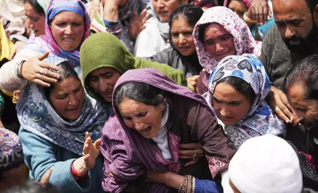 A relative wails during the funeral procession of Adil Hussain Shah, a daily-wage worker, who died when militants indiscriminately opened fire on a crowd of mainly tourists on Tuesday, at his village Hapatnar, about 20 km (13 miles) from Pahalgam where the incident took place, Indian controlled Kashmir, Wednesday, April 23, 2025. (AP Photo/Dar Yasin)