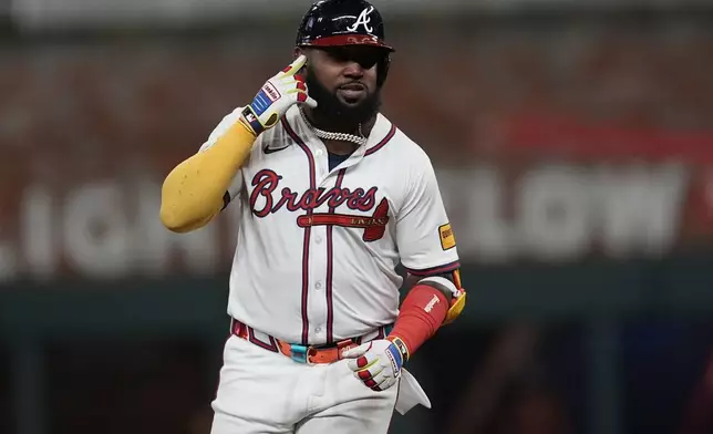 Atlanta Braves designated hitter Marcell Ozuna (20) celebrates his walk-off two-run homer against the Philadelphia Phillies in the 11th inning of a baseball game after a rain delay, Friday, April 11, 2025, in Atlanta. (AP Photo/Mike Stewart)