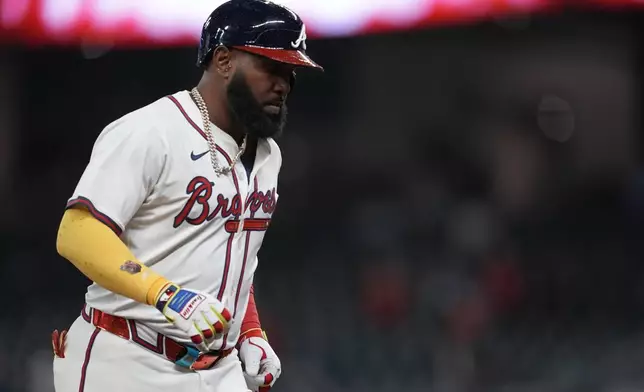 Atlanta Braves designated hitter Marcell Ozuna (20) celebrates his walk-off two-run homer against the Philadelphia Phillies in the 11th inning of a baseball game after a rain delay, Friday, April 11, 2025, in Atlanta. (AP Photo/Mike Stewart)