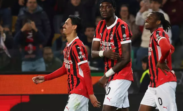 AC Milan's Tijjani Reijnders, left, celebrates scoring with teammates during the Serie A soccer match between Udinese and Milan at the Bluenergy Stadium in Udine, Italy, Friday April 11, 2025. (Andrea Bressanutti/LaPresse via AP)