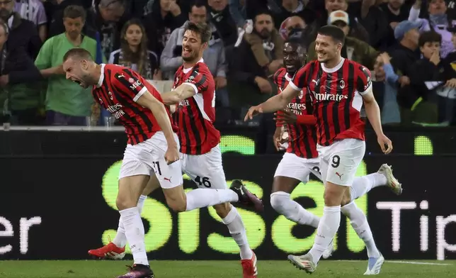 AC Milan's Strahinja Pavlovic, left, celebrates scoring during the Serie A soccer match between Udinese and Milan at the Bluenergy Stadium in Udine, Italy, Friday April 11, 2025. (Andrea Bressanutti/LaPresse via AP)