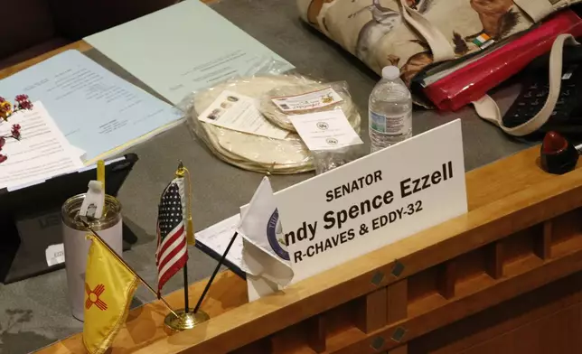 Locally made tortillas rest on the desks of New Mexico legislators as the state Senate debates a bill to designate tortillas as the official state bread in Santa Fe, on Tuesday, March 18, 2025. (AP Photo/Morgan Lee)