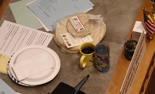Locally made tortillas rest on the desks of New Mexico legislators as the state Senate debates a bill to designate tortillas as the official state bread in Santa Fe, N.M., on Tuesday, March 18, 2025. (AP Photo/Morgan Lee)
