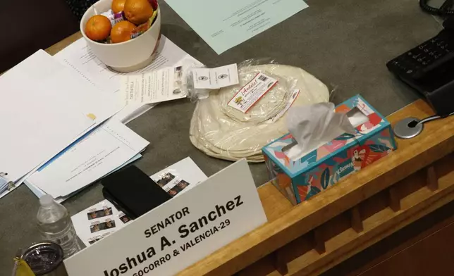 Locally made tortillas rest on the desks of New Mexico legislators as the state Senate debates a bill to designate tortillas as the official state bread in Santa Fe, N.M., on Tuesday, March 18, 2025. (AP Photo/Morgan Lee)