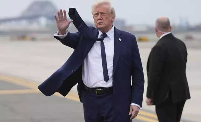 President Donald Trump waves as he arrives at Newark Liberty International Airport in Newark, N.J., Saturday, April 26, 2025, upon returning from a trip to attend the funeral of Pope Francis at the Vatican. (AP Photo/Evan Vucci)