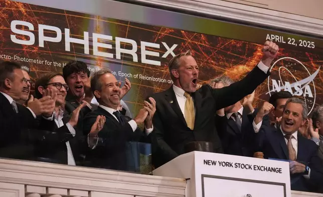 Michael P. Thelen, SPHEREx Observatory Flight System Manager, second from right, rings the closing bell ,of the New York Stock Exchange, Tuesday, April 22, 2025. (AP Photo/Richard Drew)