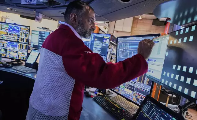 Trader Aman Patel works on the floor of the New York Stock Exchange, Wednesday, April 23, 2025. (AP Photo/Richard Drew)
