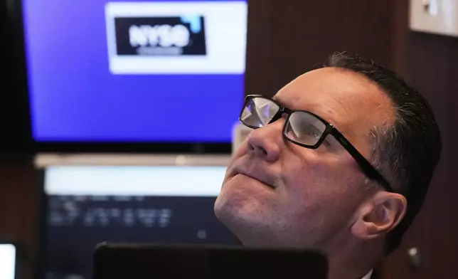 Trader Edward Curran works on the floor of the New York Stock Exchange, Monday, April 21, 2025. (AP Photo/Richard Drew)